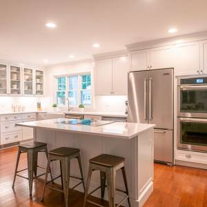 Rhode Island kitchen renovation includes seating for three at the granite topped island